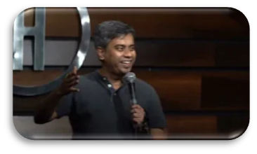 Parijat Sarkar on stage with a microphone